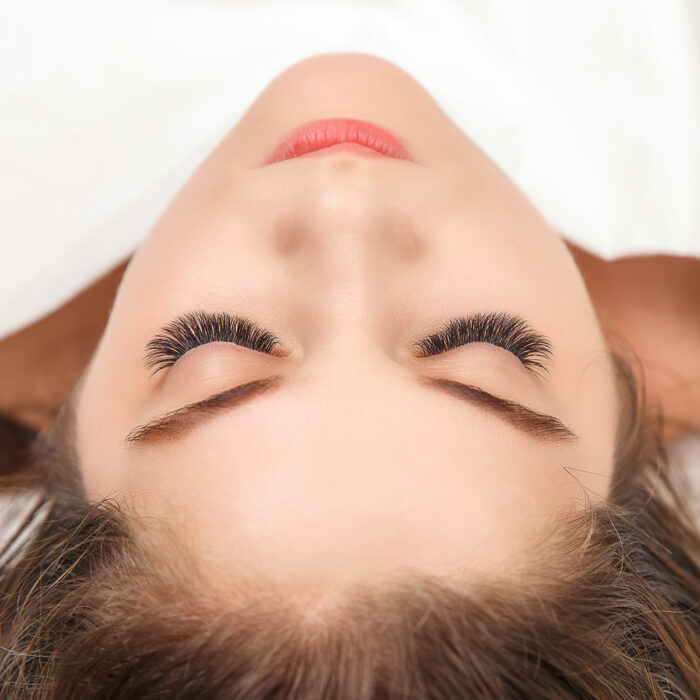 Eyelash Extension Procedure. Woman Eye with Long Eyelashes. Lashes. Close up, macro, selective focus